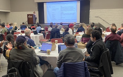 room of people at tables having a discussion