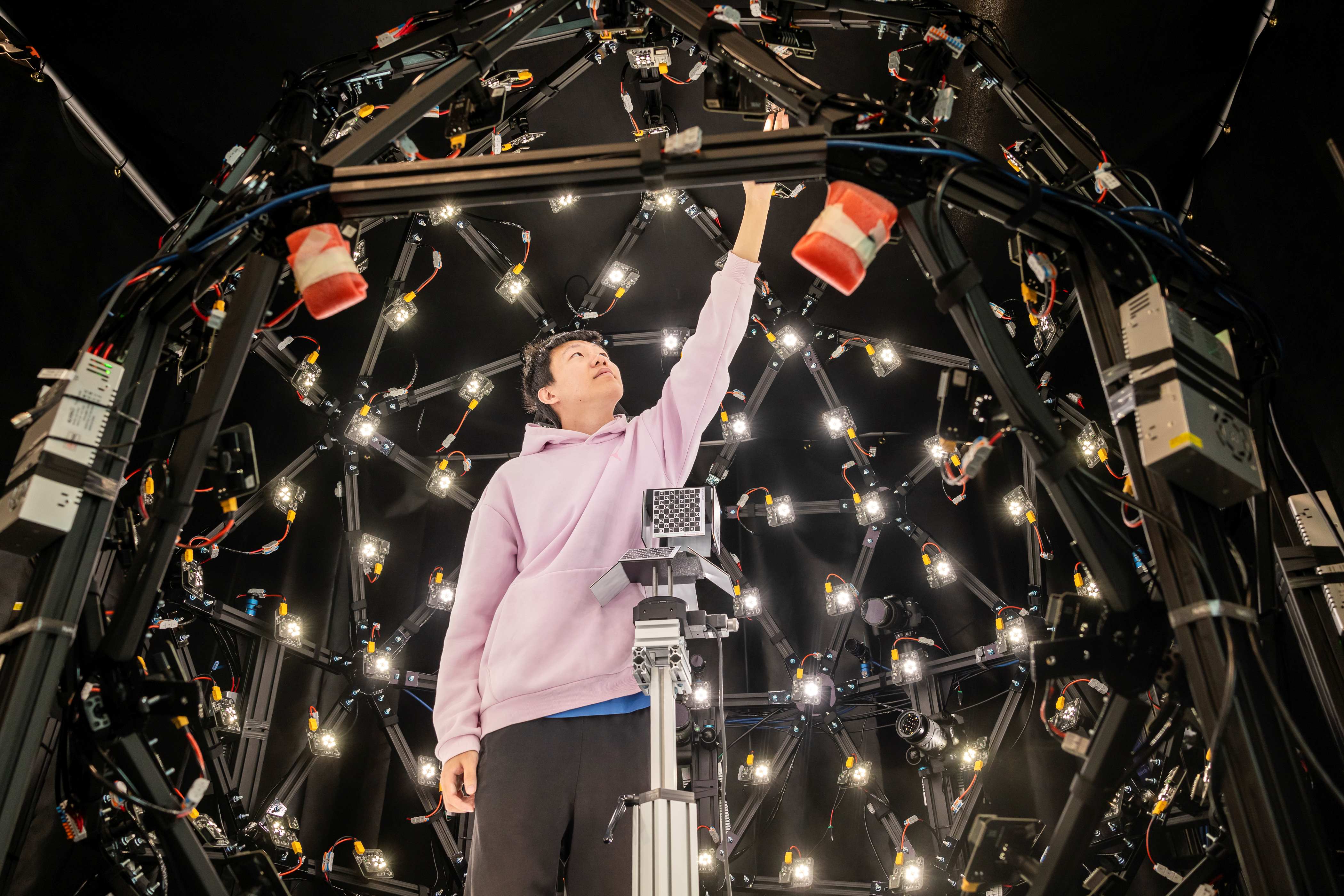 Student stands inside the Light Stage at the Imaging and Vision Lab at Mason Square
